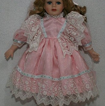 Standing Porcelain 16 Inches Doll Clothed in a Soft Pink Dress, Lace Trimmed Dress and Satin Ribbon Bow on Her Hair That Brings Out Its Big Blue Eyes, This Porcelain Doll Exhibits a Demure Elegance image